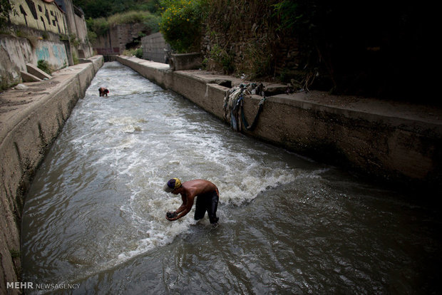 Searching for gold in wastewater channels in Venezuela