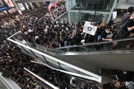 Hong Kong flights cancelled as thousands protest at airport after night of violence
