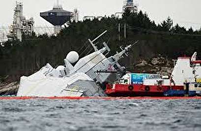 Shipwrecked Norwegian navy frigate sinking further, nearly submerged